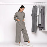 Right View of a Model wearing Charcoal Grey Handspun Straight Ankle Length Jumpsuit