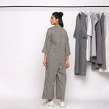 Back View of a Model wearing Charcoal Grey Handspun Straight Ankle Length Jumpsuit