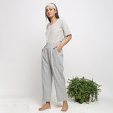 Left View of a Model wearing Off-White Checkered Cotton Muslin Elasticated Mid-Rise Pant