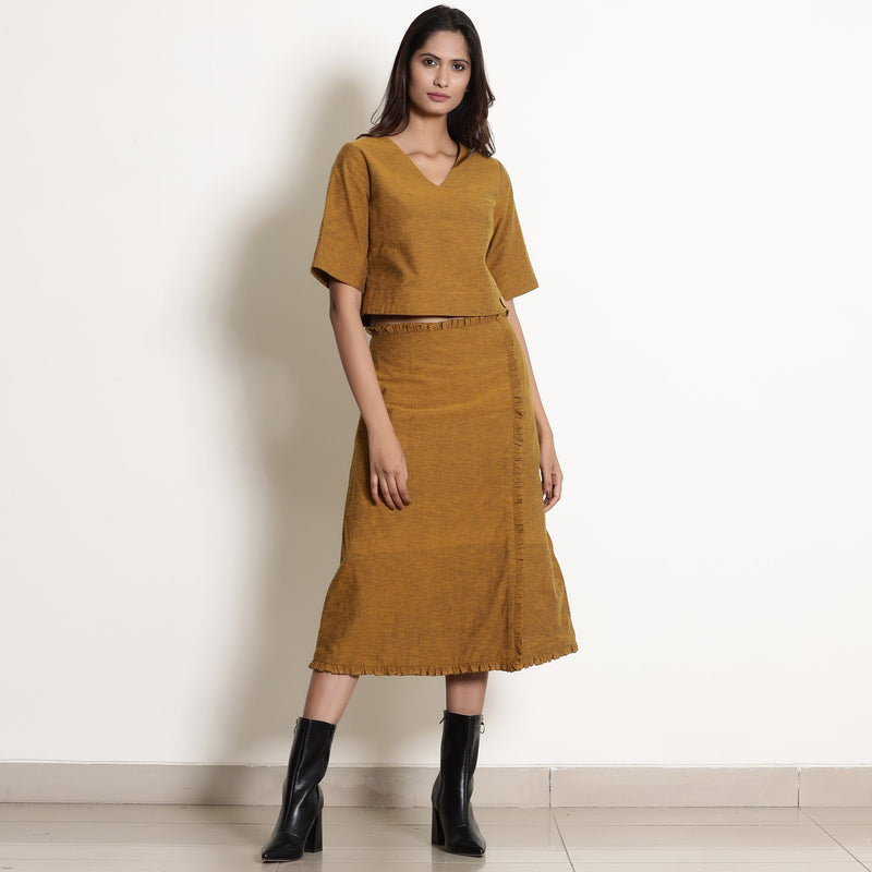 Front View of a Model wearing Chic Warm Golden Oak Wrap Top and Skirt Set