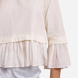 Close View of a Model wearing White Frilled Cotton Peplum Top