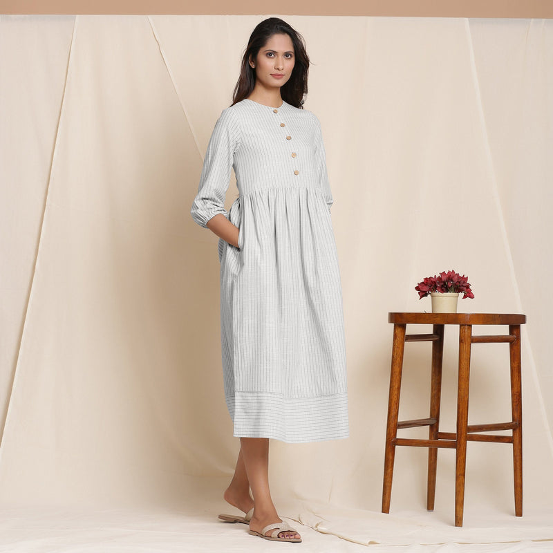 Right View of a Model wearing Cloudy Grey Button Down Gathered Dress