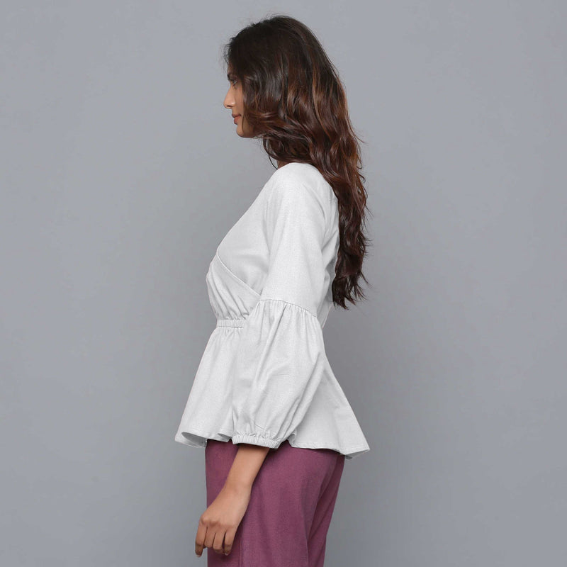 Left View of a Model wearing Cloudy Grey V-Neck Flannel Peplum Top