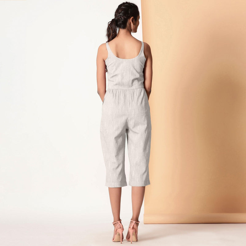 Back View of a Model wearing Grey Cotton Sleeveless Button-Down Jumpsuit