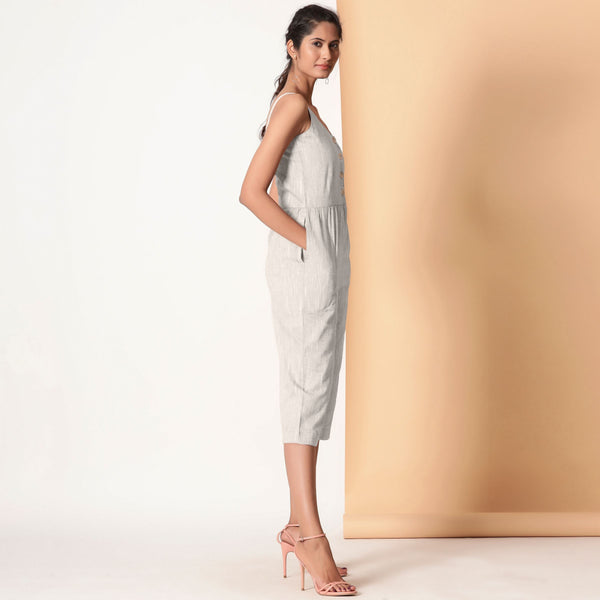 Right View of a Model wearing Grey Cotton Sleeveless Button-Down Jumpsuit