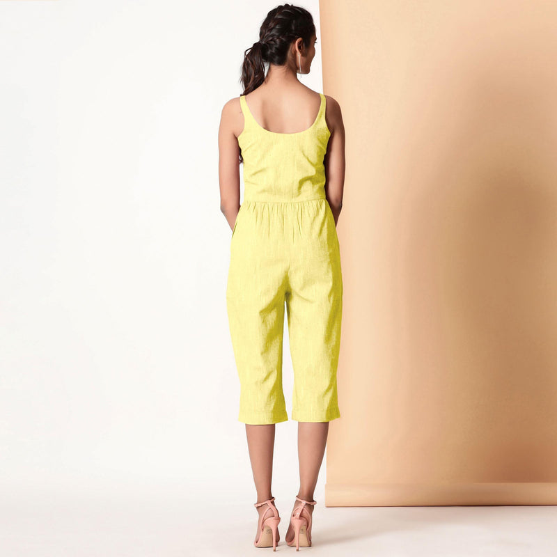 Back View of a Model wearing Lemon Yellow Cotton Sleeveless Button-Down Jumpsuit