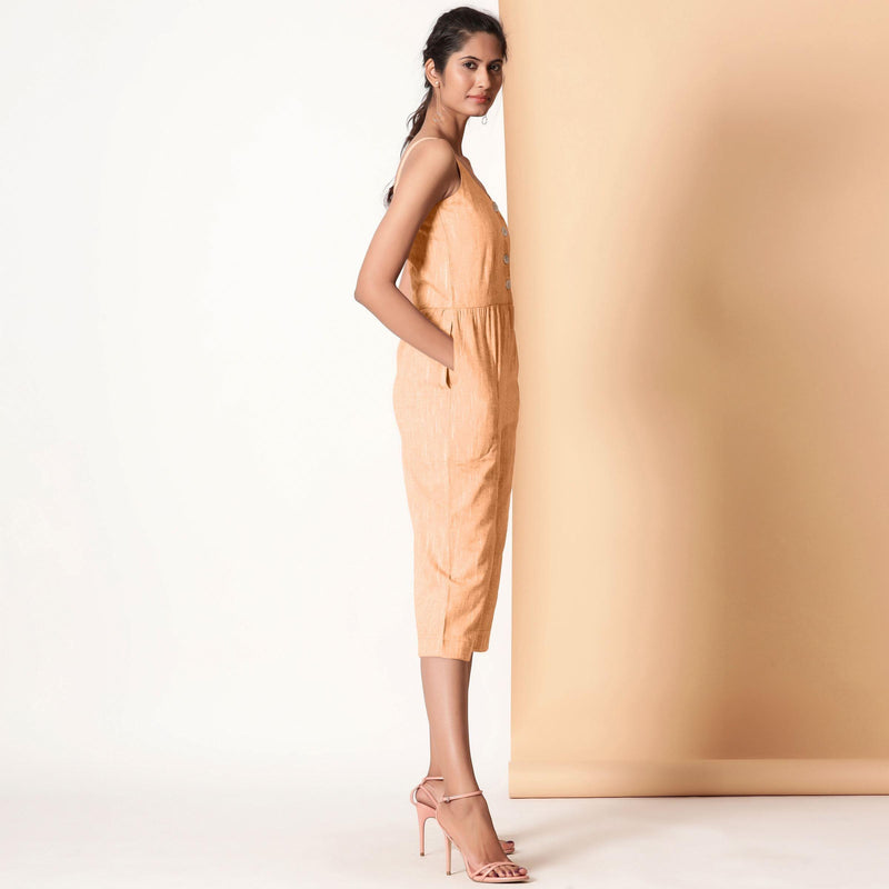 Right View of a Model wearing Yellow Cotton Sleeveless Button-Down Jumpsuit