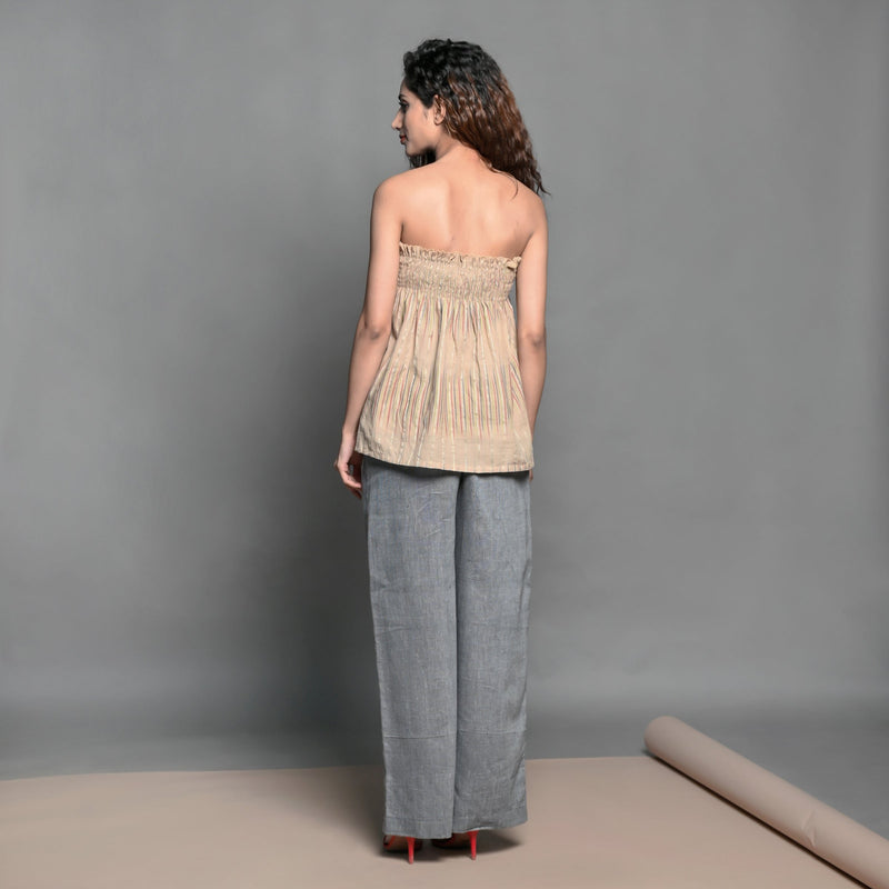 Back View of a Model wearing Convertible Beige Handwoven Cotton Shirred Top Skirt