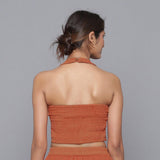 Back View of a Model wearing Sunset Rust Corduroy Halter Neck Top