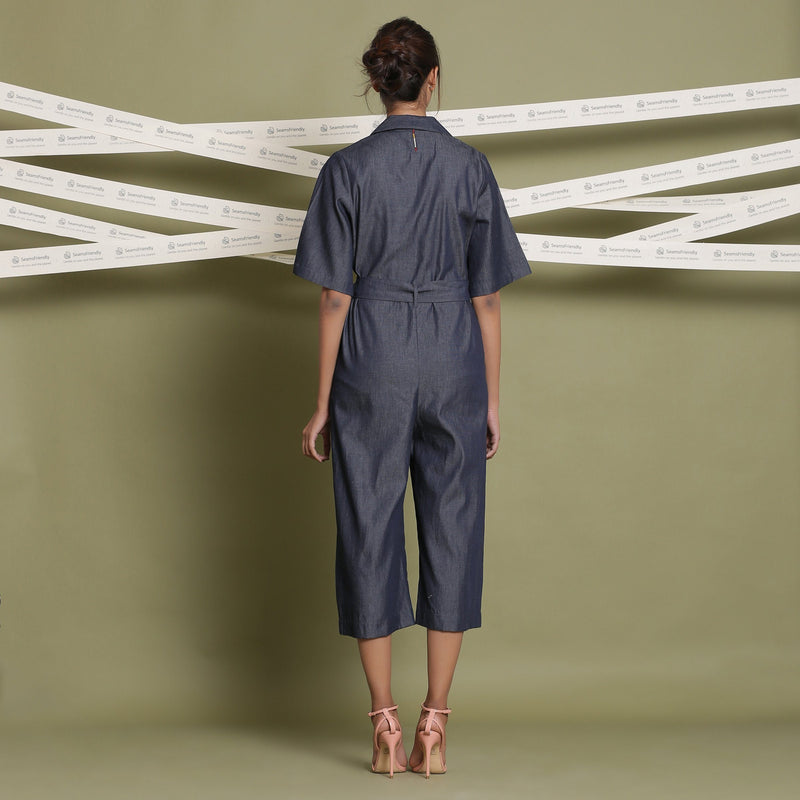 Back View of a Model wearing Cotton Denim Loose Fit Flared Jumpsuit