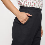 Right Detail of a Model wearing Cotton Flax Mid-Rise Black Tapered Pant