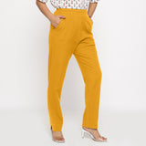 Right View of a Model wearing Cotton Flax Mid-Rise Yellow Tapered Pant