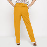 Back View of a Model wearing Cotton Flax Mid-Rise Yellow Tapered Pant