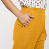 Right Detail of a Model wearing Cotton Flax Mid-Rise Yellow Tapered Pant