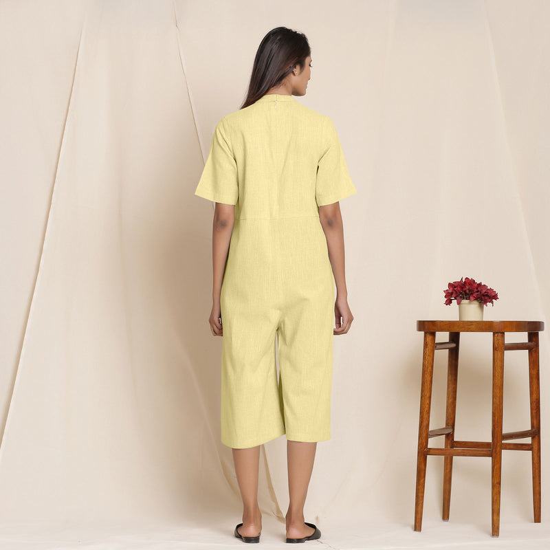 Back View of a Model wearing Cotton Lemon Yellow Box Pleated Jumpsuit