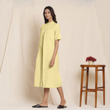 Left View of a Model wearing Cotton Lemon Yellow Box Pleated Jumpsuit