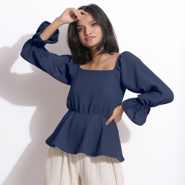 Front View of a Model wearing Cotton Waffle Navy Blue Peplum Top