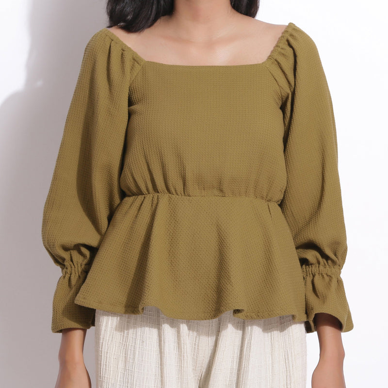 Front Detail of a Model wearing Cotton Waffle Olive Green Peplum Top