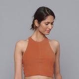 Front View of a Model wearing Sunset Rust Corduroy Halter Neck Top