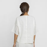 Back View of a Model wearing Hand Embroidered Organic Cotton Paneled Top