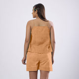 Back View of a Model wearing Desert Yellow 100% Linen Flared Camisole Top