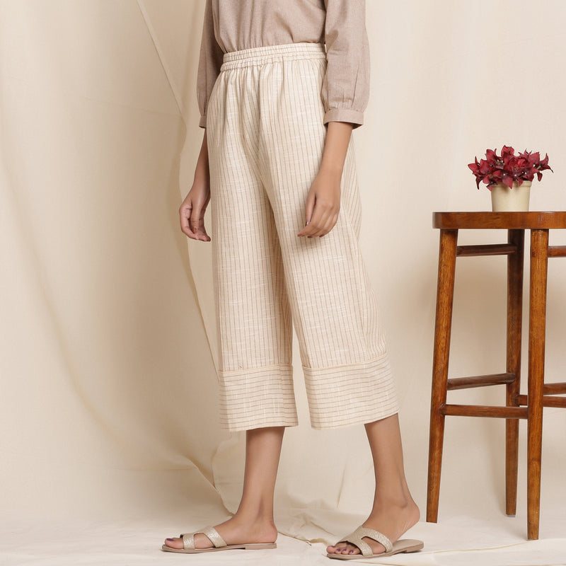 Left View of a Model wearing Dusk Beige Warm Cotton Culottes Striped Pant