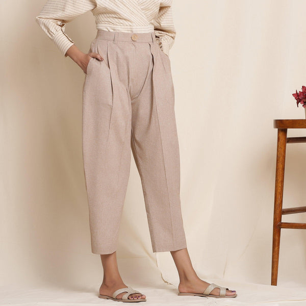 Right View of a Model wearing Dusk Brown Box Pleated Pegged Pant