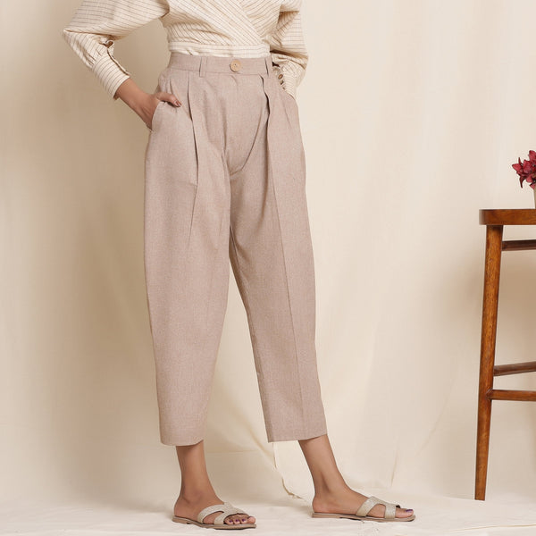 Right View of a Model wearing Dusk Brown Box Pleated Pegged Pant