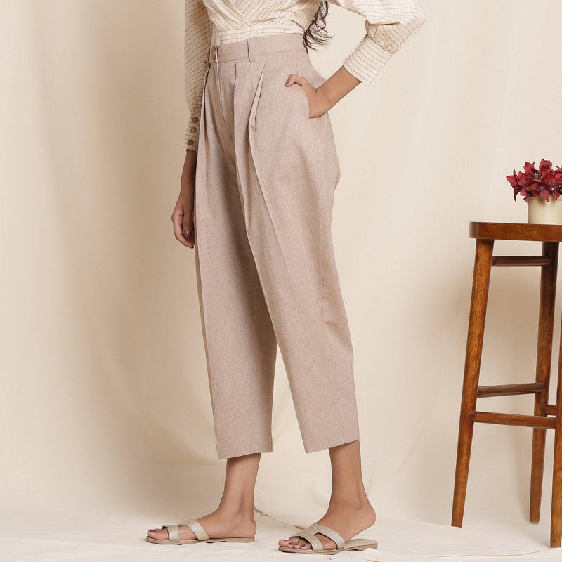 Left View of a Model wearing Dusk Brown Box Pleated Pegged Pant
