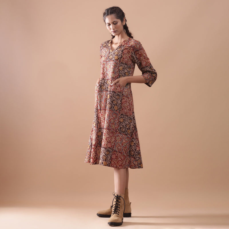 Left View of a Model wearing Warm Block Printed Muddy Red Cotton Midi Dress