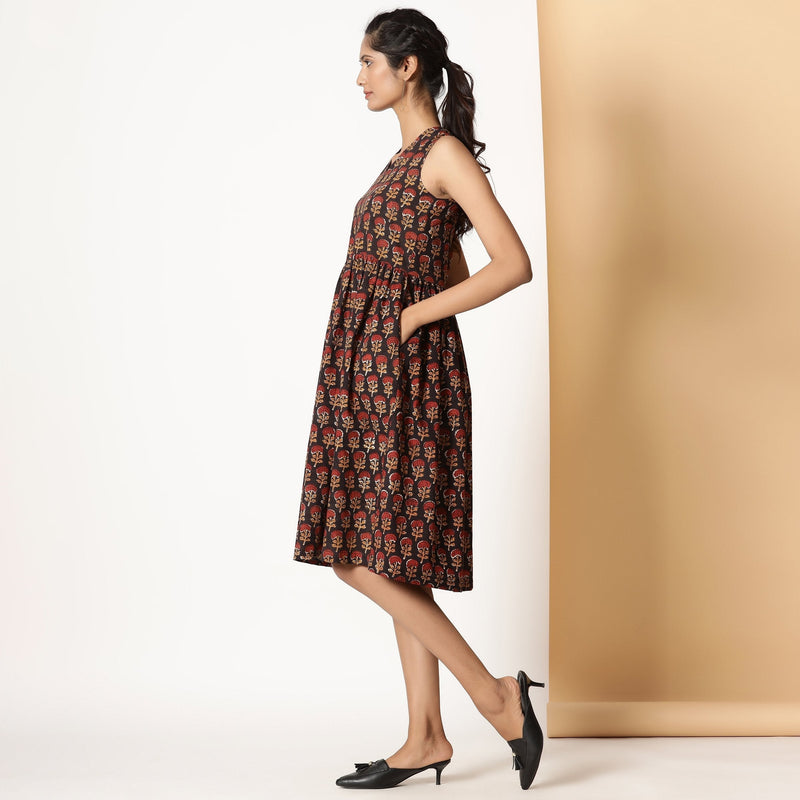 Left View of a Model wearing Floral Block Printed Gathered Knee Length Cotton Dress