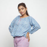 Left View of a Model wearing Blue Floral Block Printed Balloon Cotton Top