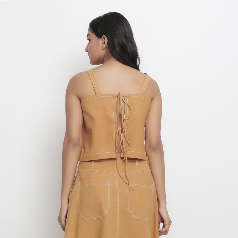 Back View of a Model Wearing Minimal Handspun Rust Top and Skirt Set