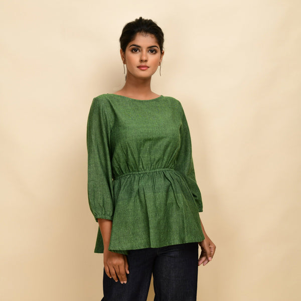 Front View of a Model wearing Forest Green Yarn Dyed Cotton Round Neck Peplum Top