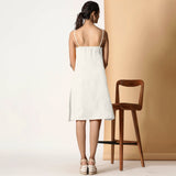 Back View of a Model wearing Frosted White Cotton Flax Strappy Slit Dress