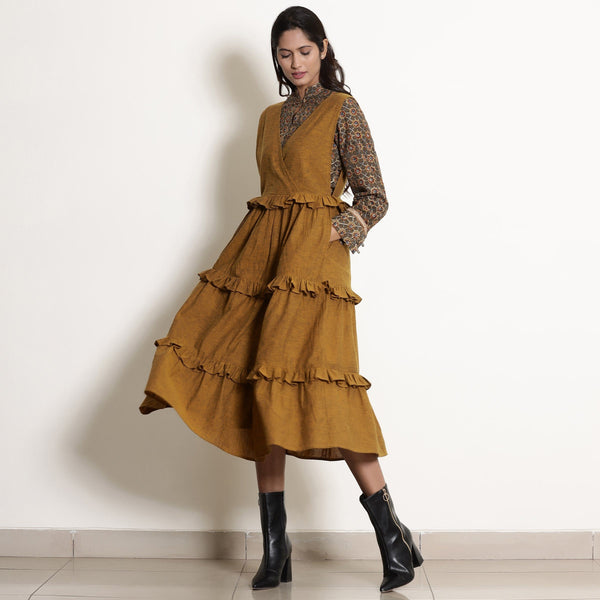 Front View of a Model wearing Golden Oak Tier Pinafore Frilled Dress