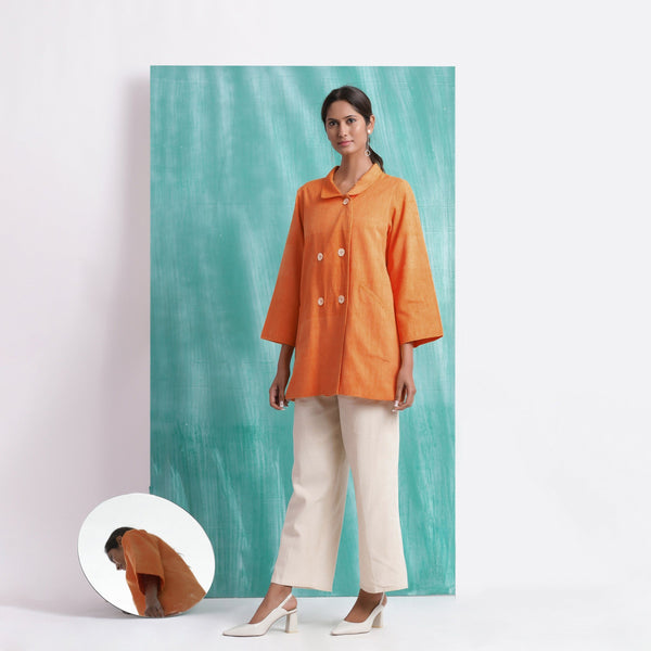 Front View of a Model wearing Handwoven Orange Welt Pocket Coat