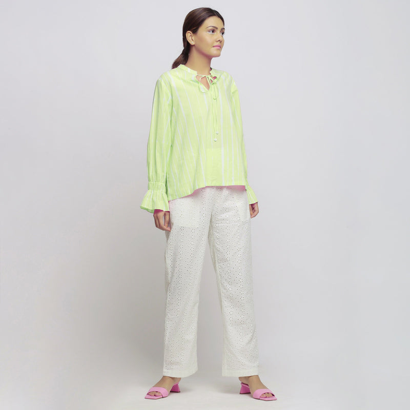 Right View of a Model wearing Green Blouson Top and Schiffli White Pant Set