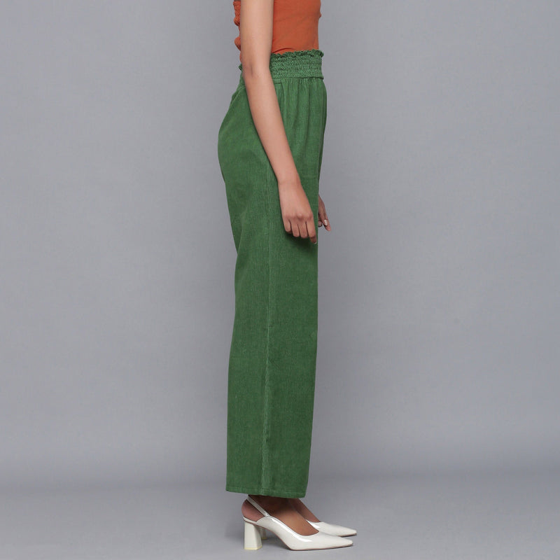 Right View of a Model wearing Green Corduroy Striped Bootcut Pant