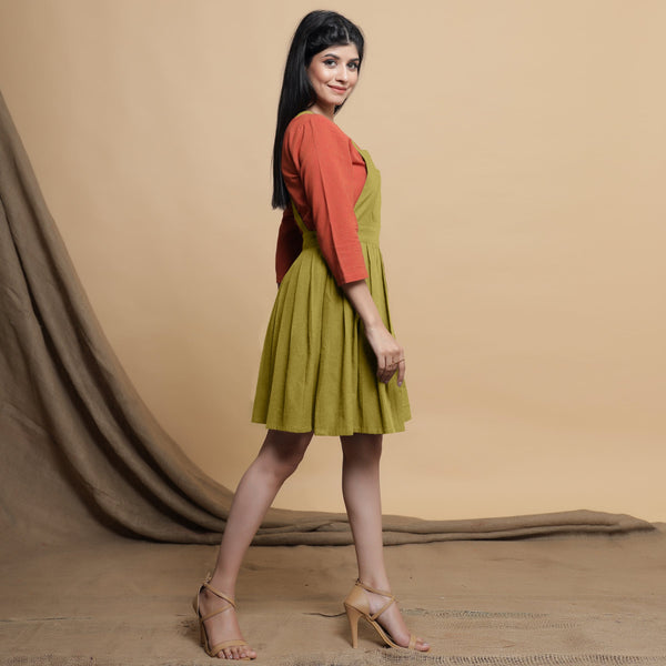 Right View of a Model wearing Green Pleated Cotton Flax Knee Length Criss-Cross Back Dress