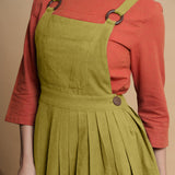Front Detail of a Model wearing Green Pleated Cotton Flax Knee Length Criss-Cross Back Dress