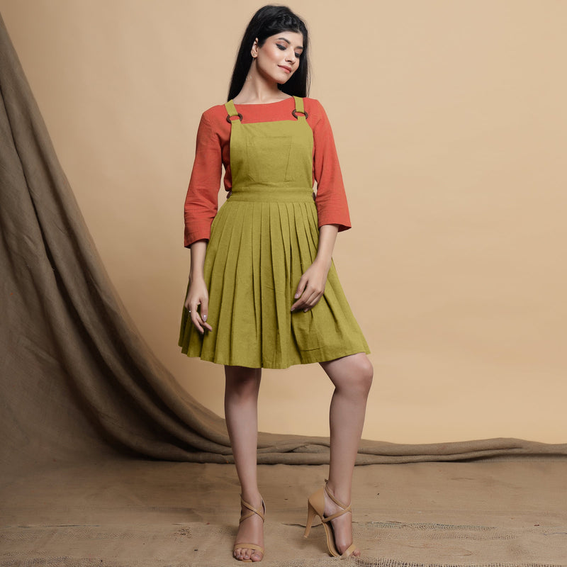 Front View of a Model wearing Green Pleated Cotton Flax Knee Length Criss-Cross Back Dress