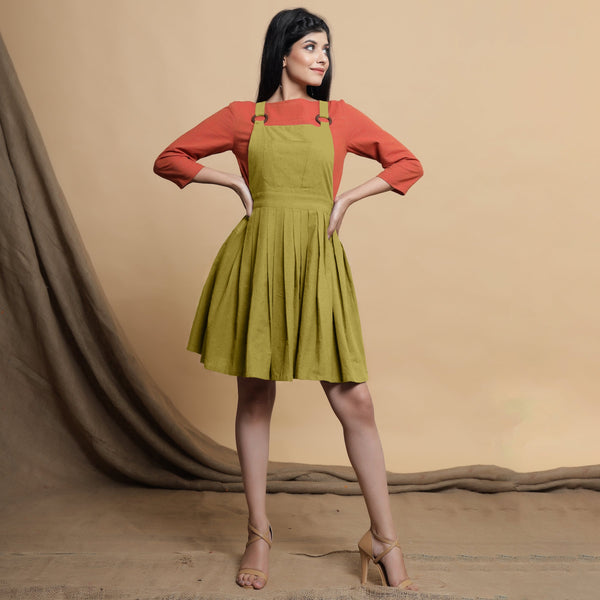 Front View of a Model wearing Green Pleated Cotton Flax Knee Length Criss-Cross Back Dress