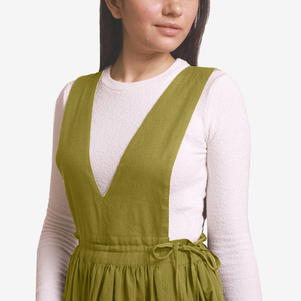 Front Detail of a Model wearing Green Deep Neck Pinafore Midi Wrap Dress