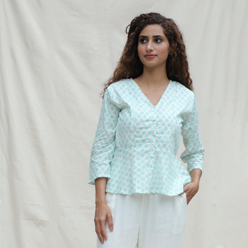 Front View of a Model wearing Green Floral Block Printed Cotton Button-Down Peplum Top