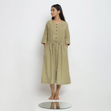 Front View of a Model wearing Green Vegetable Dyed Handspun Cotton Round Neck Button-Down Midi Dress