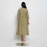 Back View of a Model wearing Green Vegetable Dyed Handspun Cotton Round Neck Button-Down Midi Dress