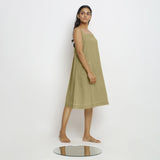 Right View of a Model wearing Green Vegetable Dyed Handspun Slip Dress