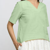 Front Detail of a Model wearing Green Yarn Dyed 100% Cotton V-Neck High-Low Top