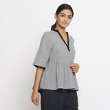 Right View of a Model wearing Solid Grey Yarn Dyed Cotton Peplum Top